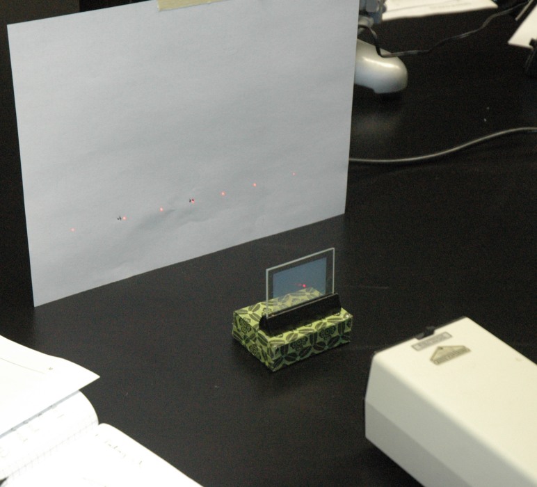 laser going through grating onto paper